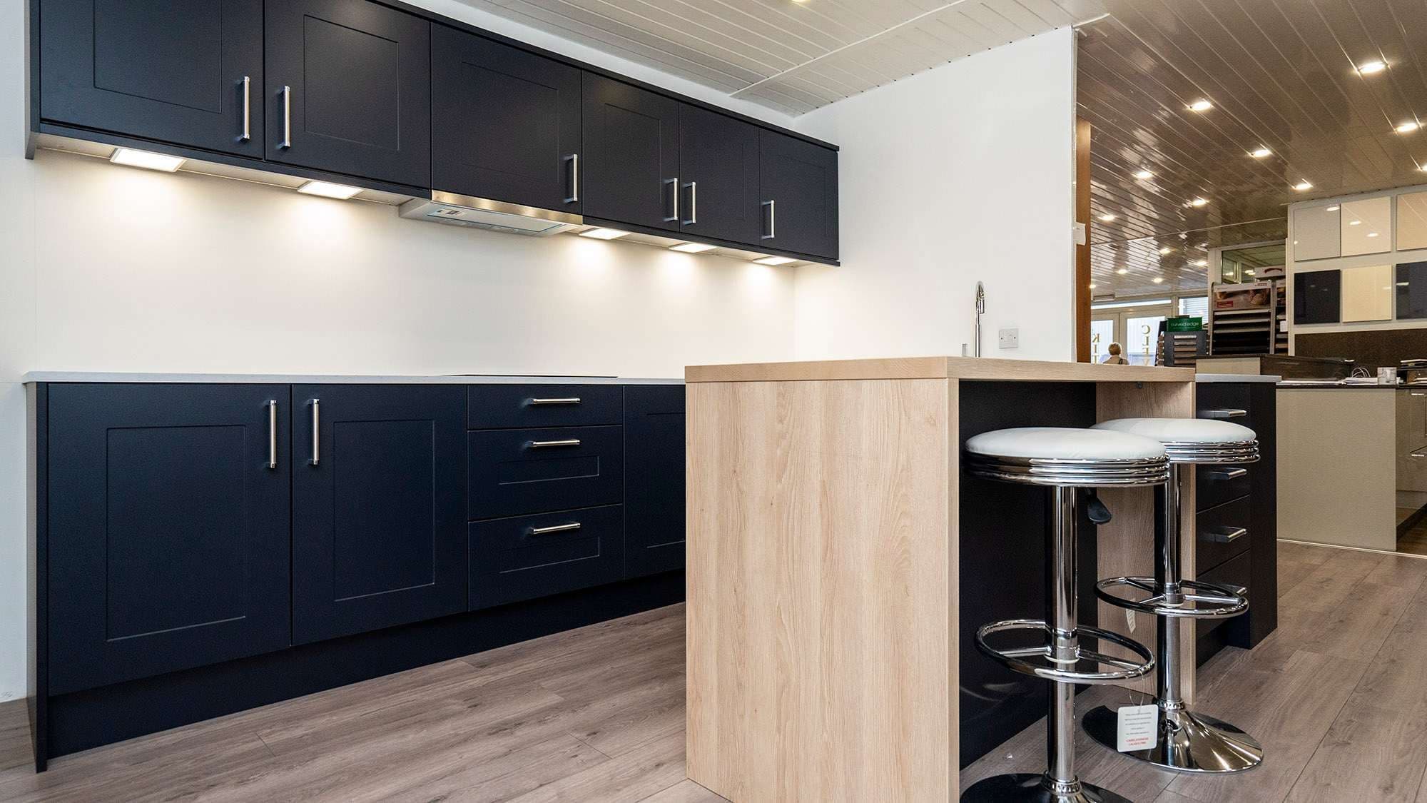 Navy kitchen with breakfast bar and chrome stools