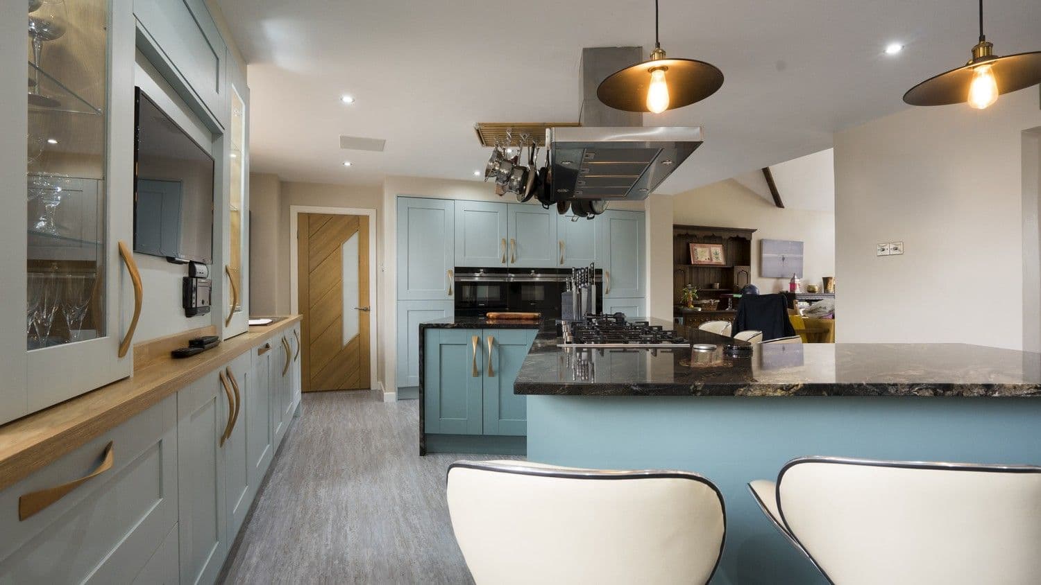 Blue shaker kitchen featuring a large central cooking hob with extractor fan, a perfect setup for any keen chef.