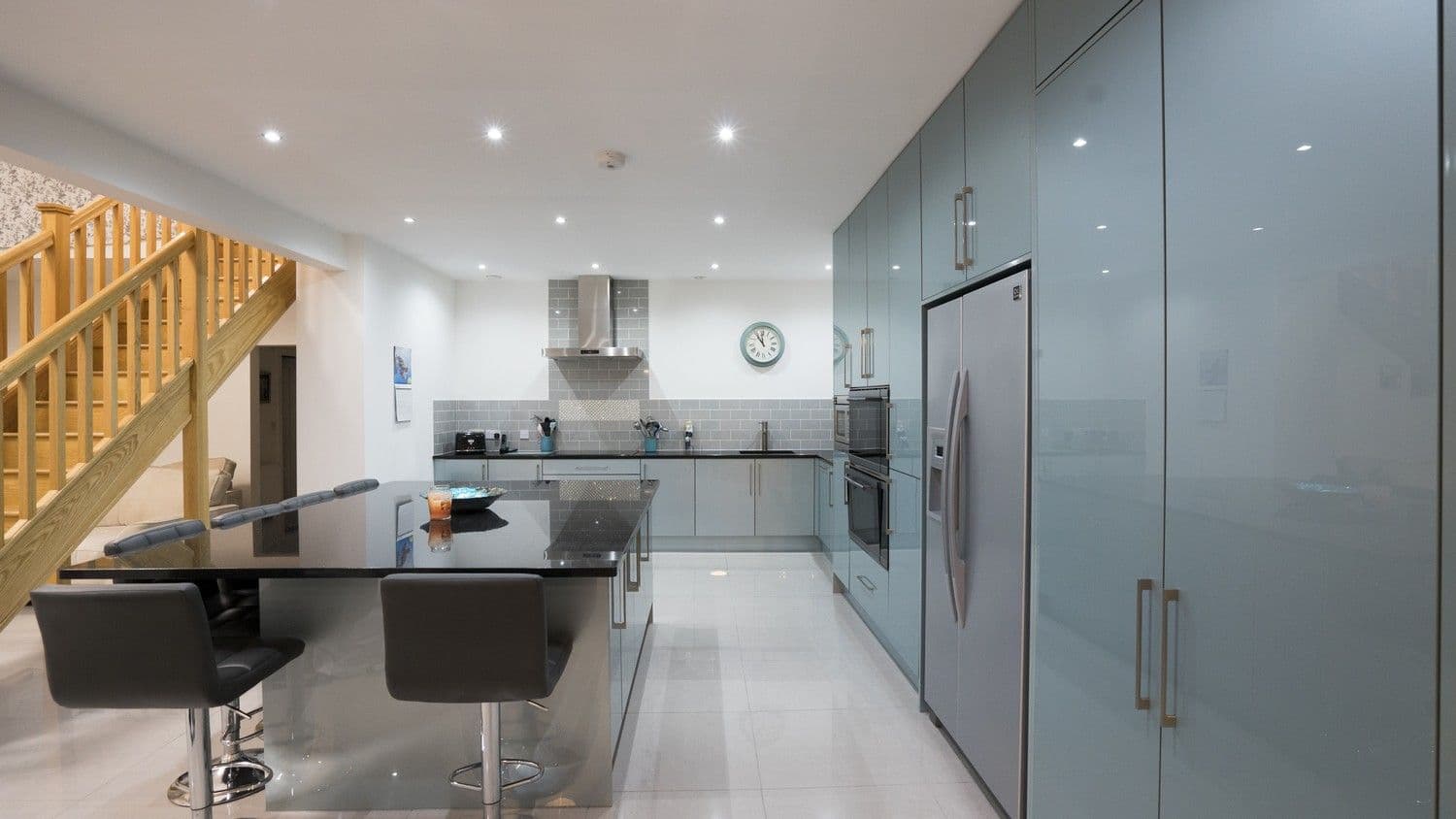 Straight on view of this large kitchen highlighting the open plan living space this kitchen leads on to.
