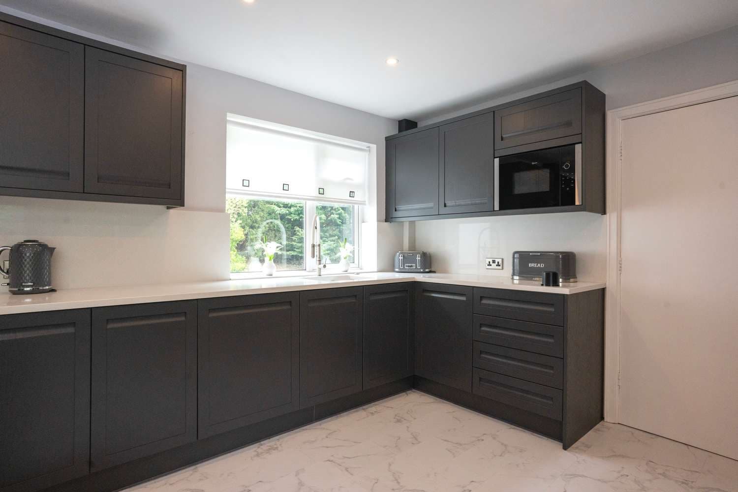 Corner view of painted ash kitchen.