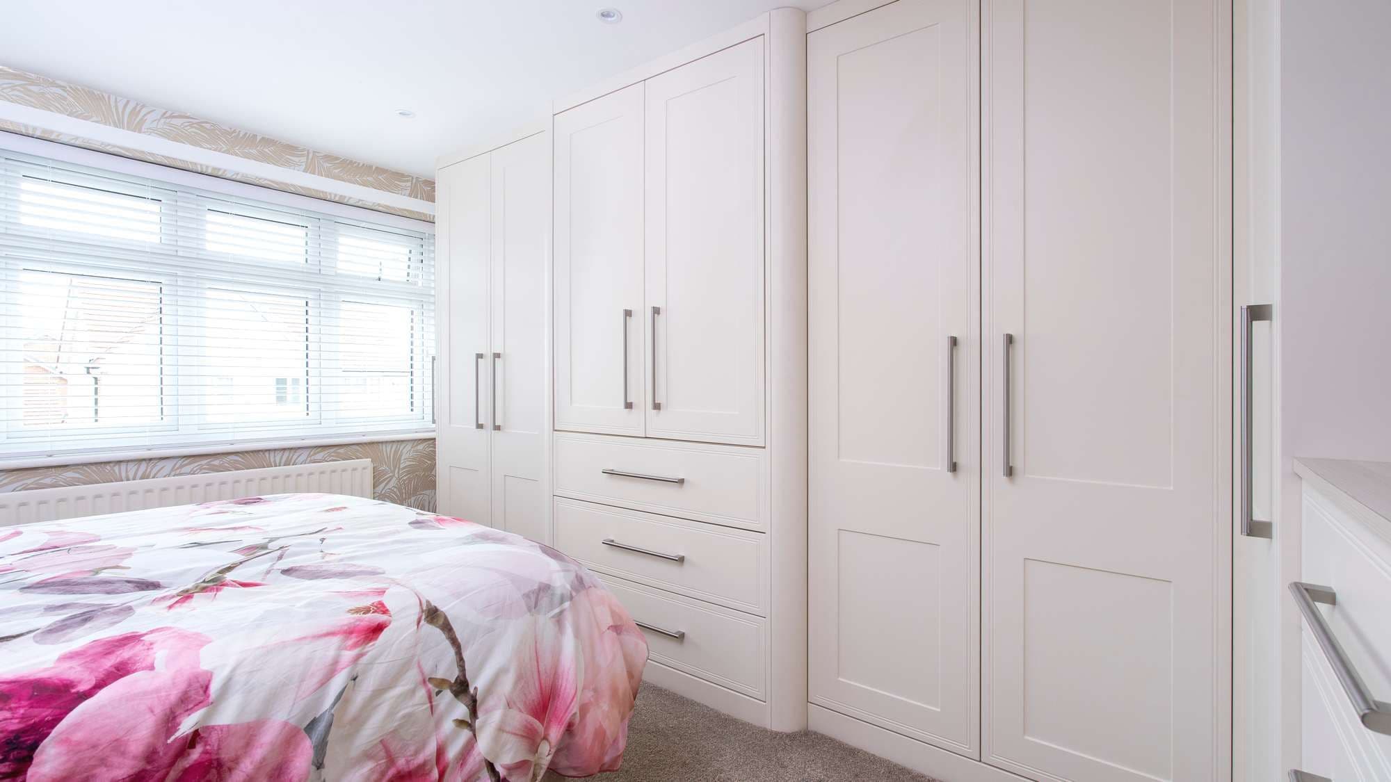 Cream shaker fitted wardrobes in Woolton, featuring a large bar handle.