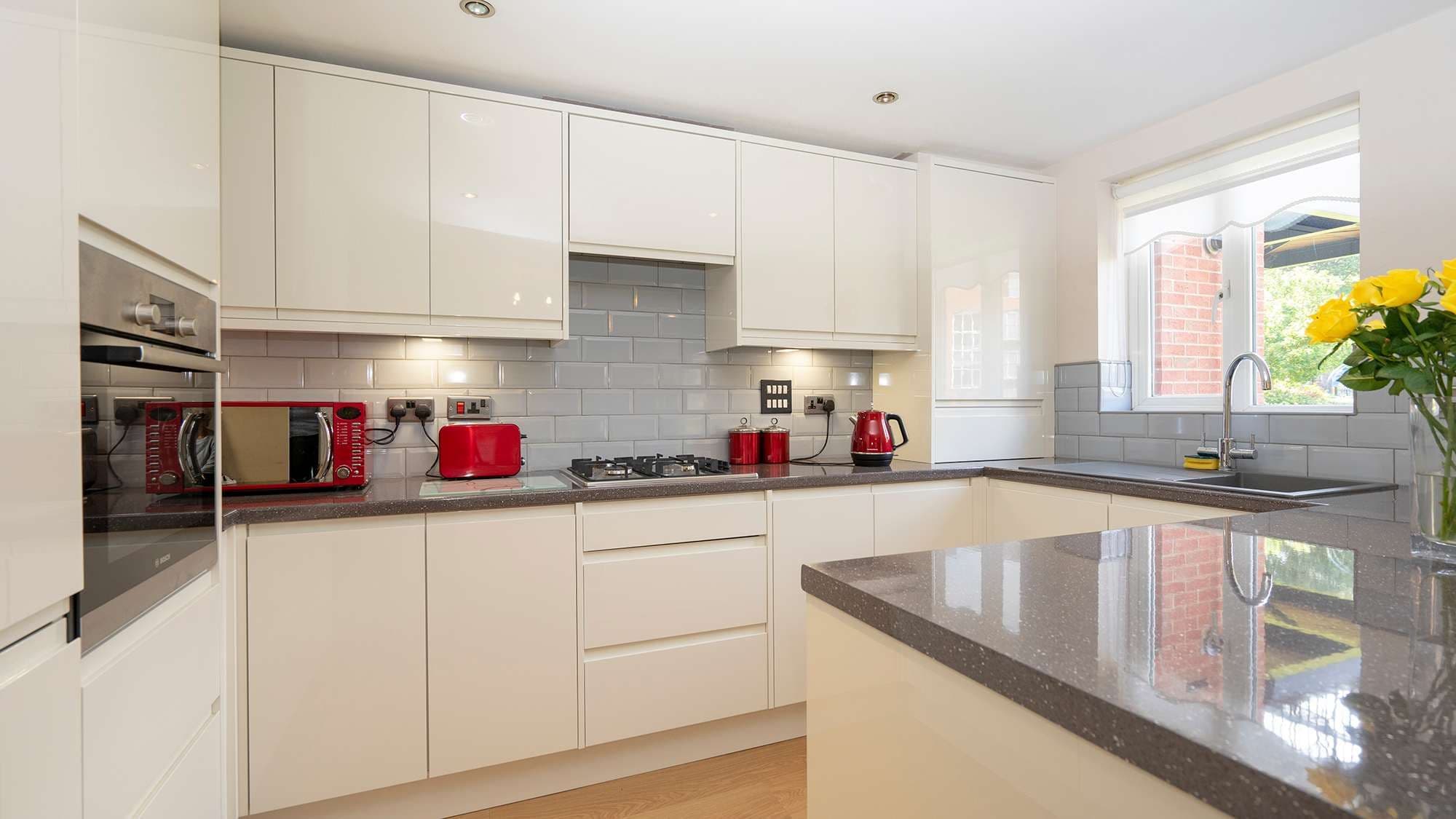 Cream gloss handle-less kitchen supplied and fitted to an apartment block in Liverpool.