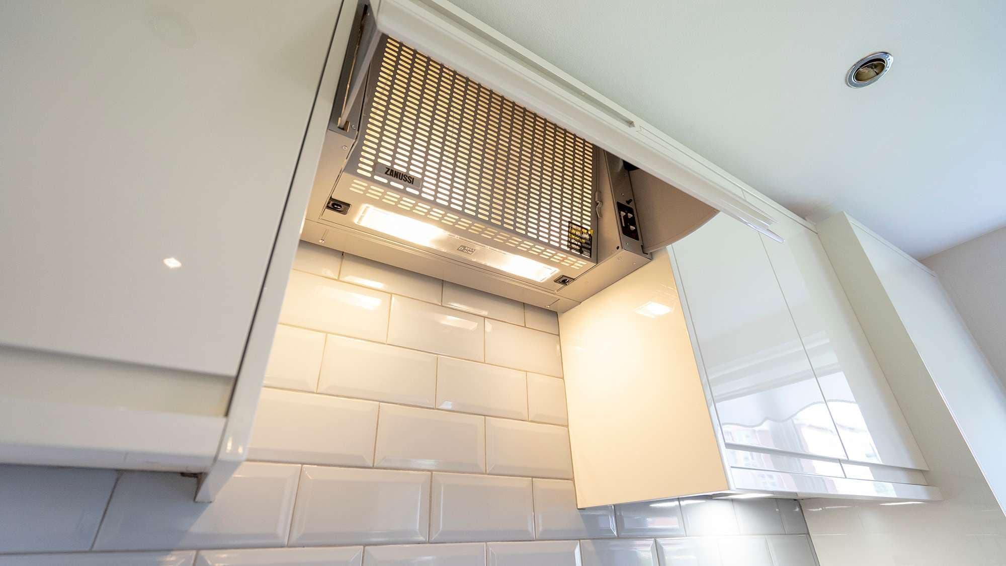 Close up of the built in extractor fan housed within a cupboard door.