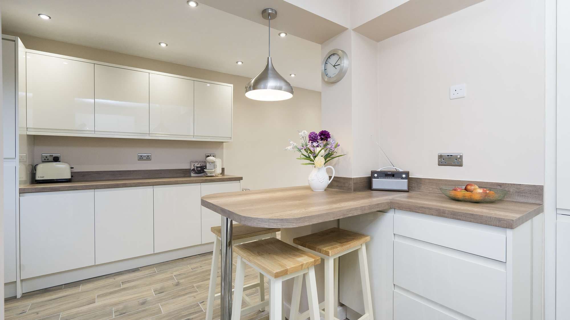 Close up of the seating area in this gloss cream kitchen we installed in Warrington.