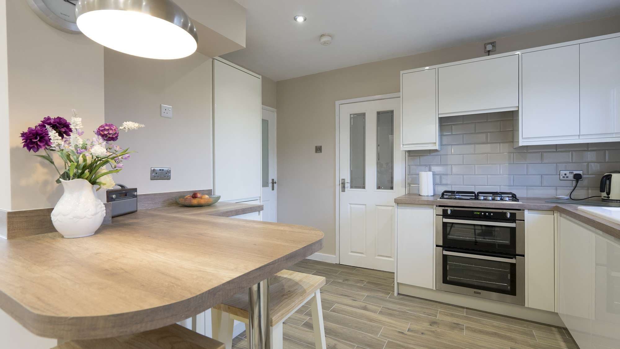 Another view of the island area, looking into the main kitchen with cooking and cleaning areas.