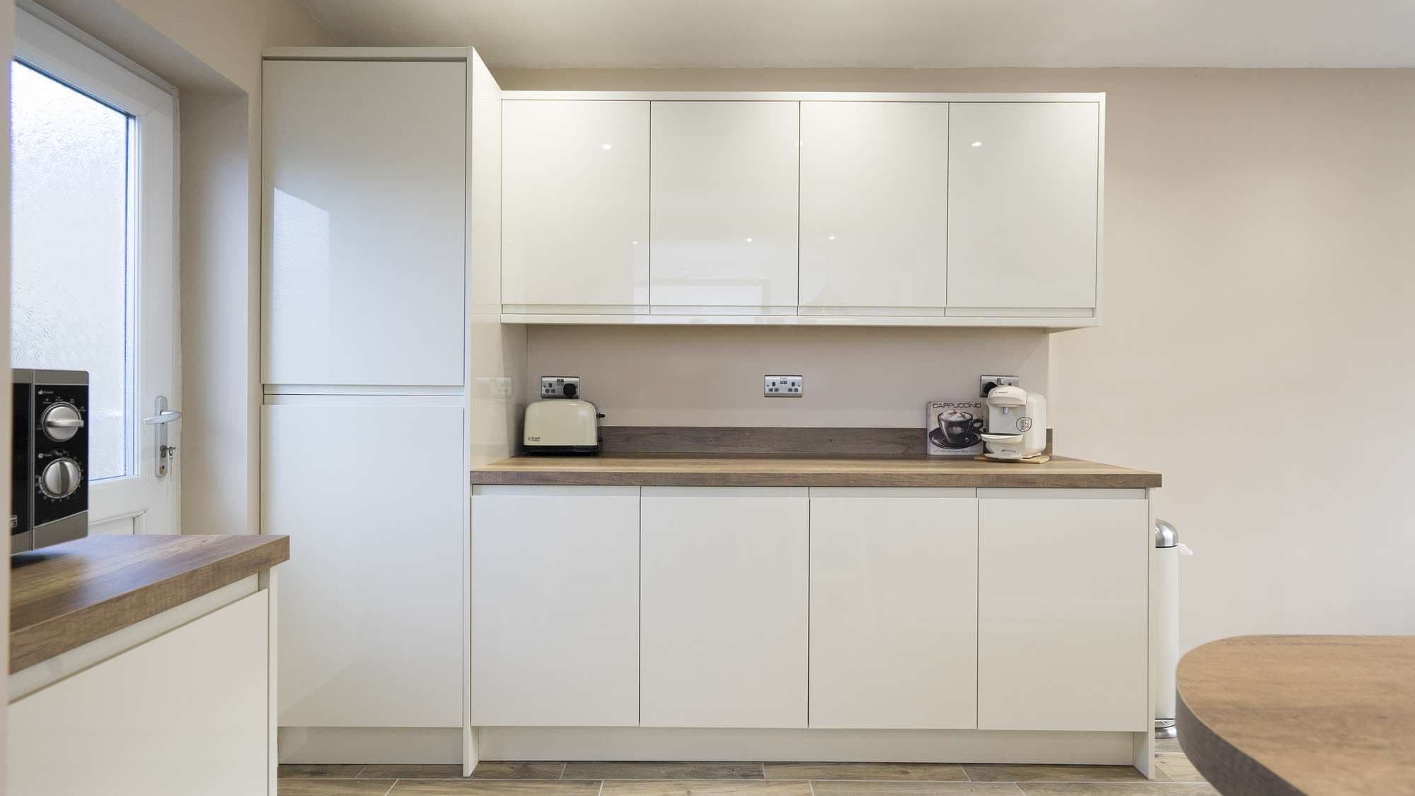 Straight on shot of the handleless kitchen cabinets.,