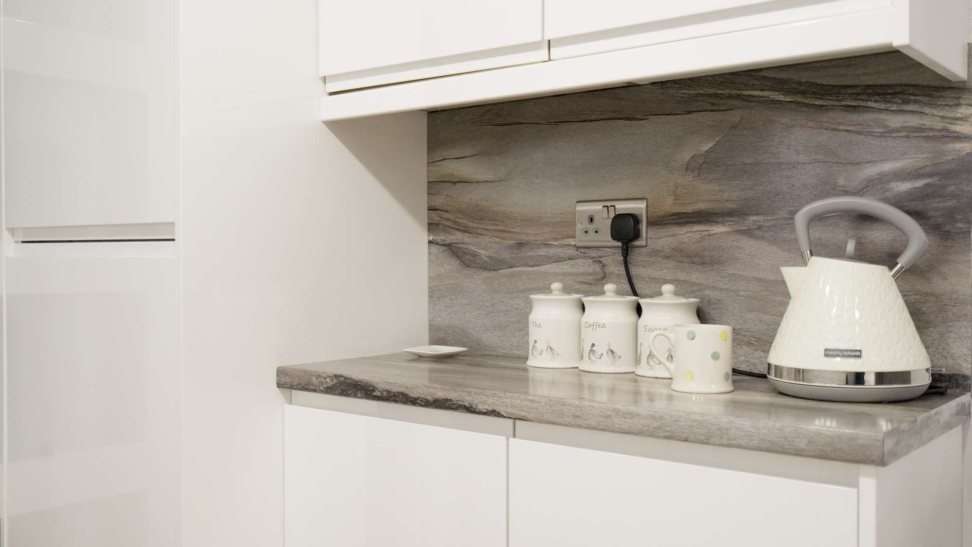 Close up view of the drinks area in this newly refurbished gloss white handle-less kitchen.