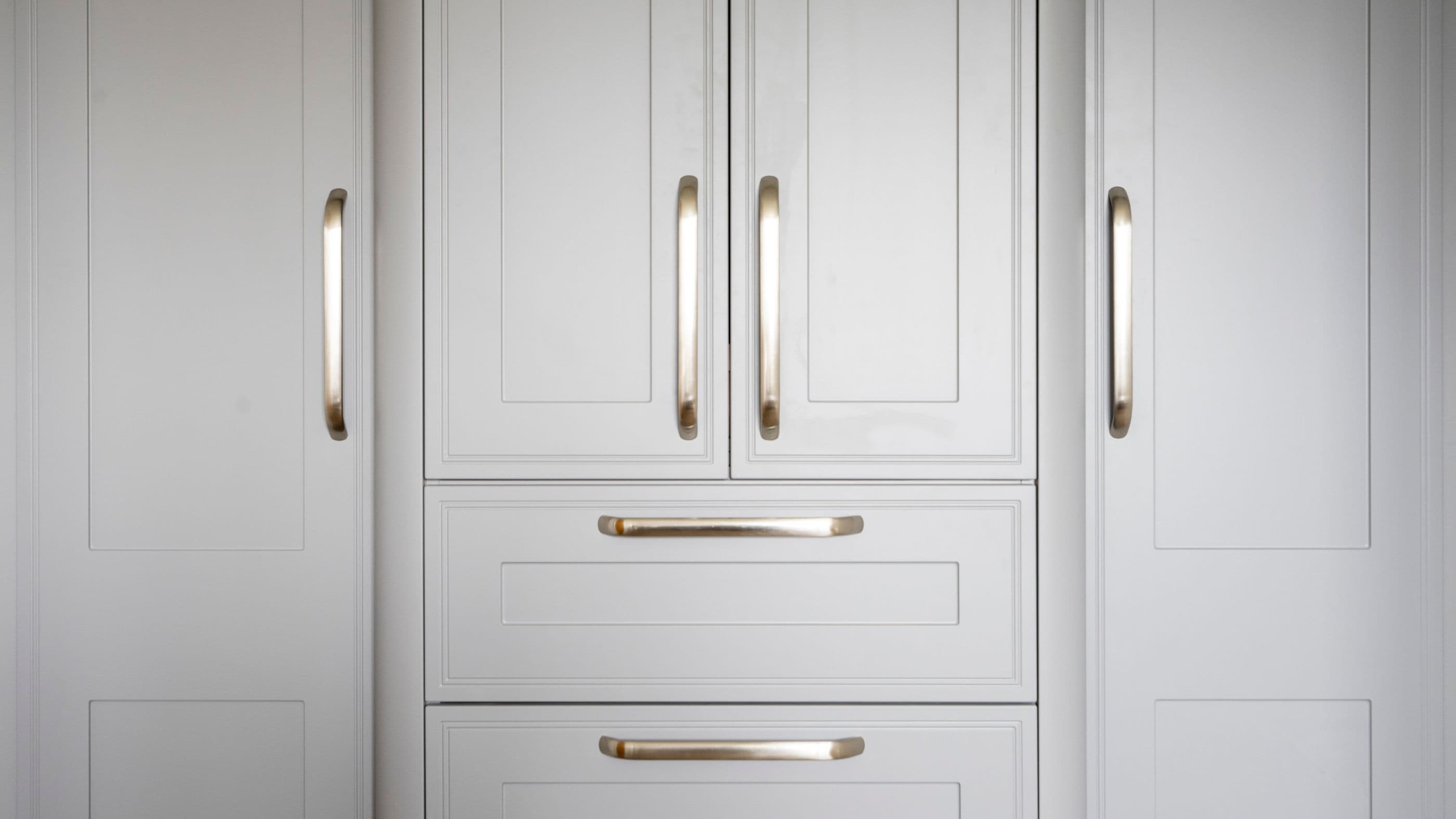 Close up view of the modern stainless steel handles and shaker door detailing in Liverpool.
