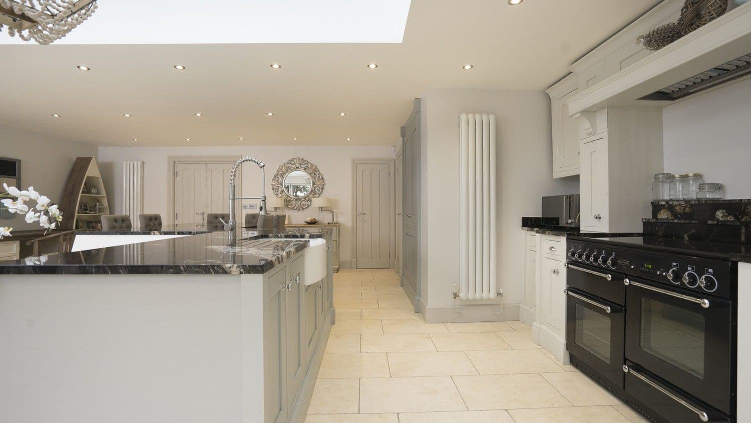 Close up of the central island with a stunning granite worktop, ceramic sink and stainless steel feature tap.