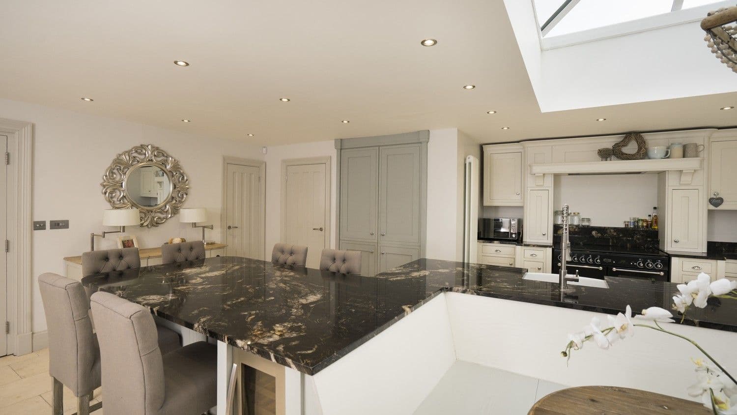 At the other end of this uniquely shaped island is a seating area which is perfect for entertaining friends and family. Integrated into this island is a drinks chiller.