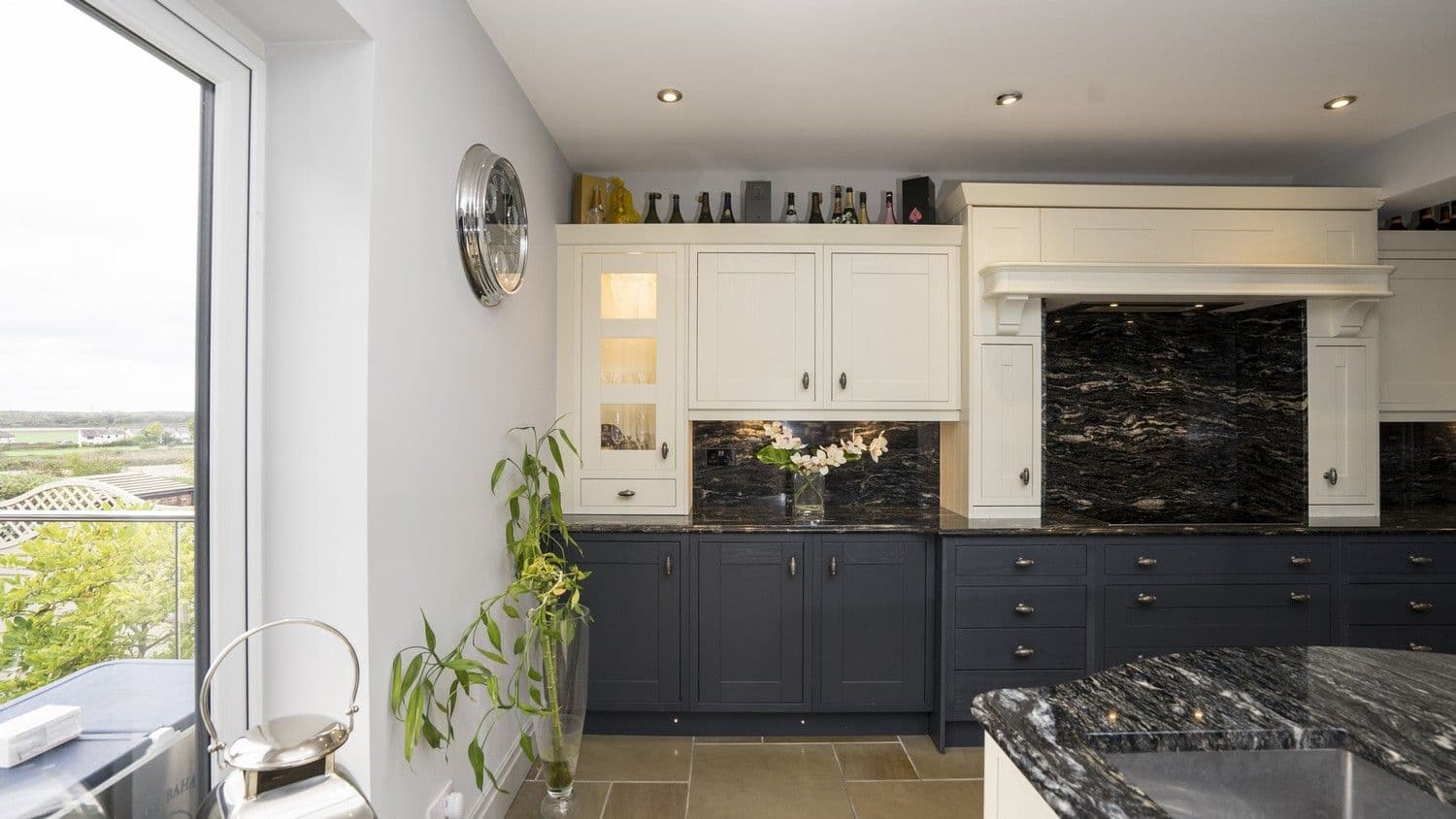 Alternative shot highlighting the kitchen units lighting detail and view through the bifolding door to the garden. What a stunning Ormskirk kitchen this is.