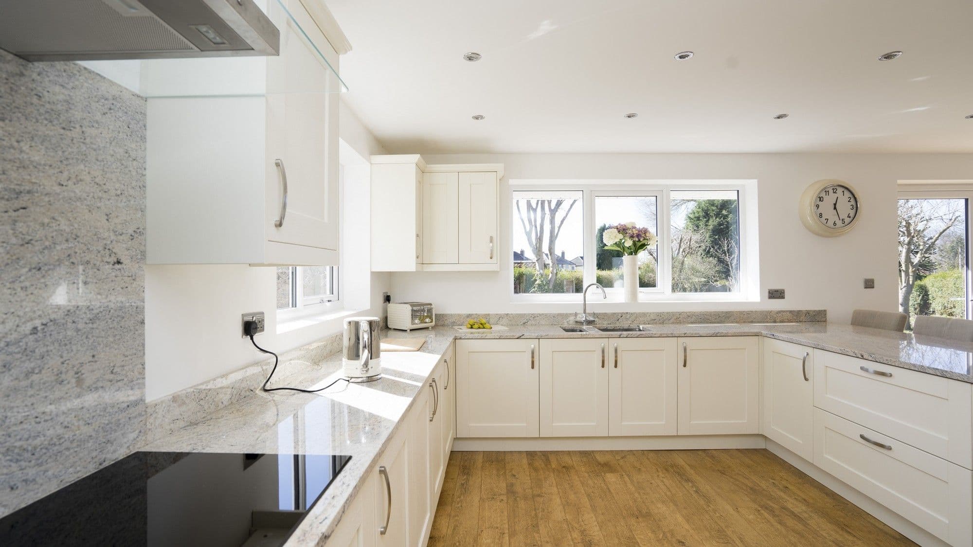 Straight on view of this new kitchen featuring a Neff hob and extractor, Granite splash back and a range of Cleveland Kitchen units.