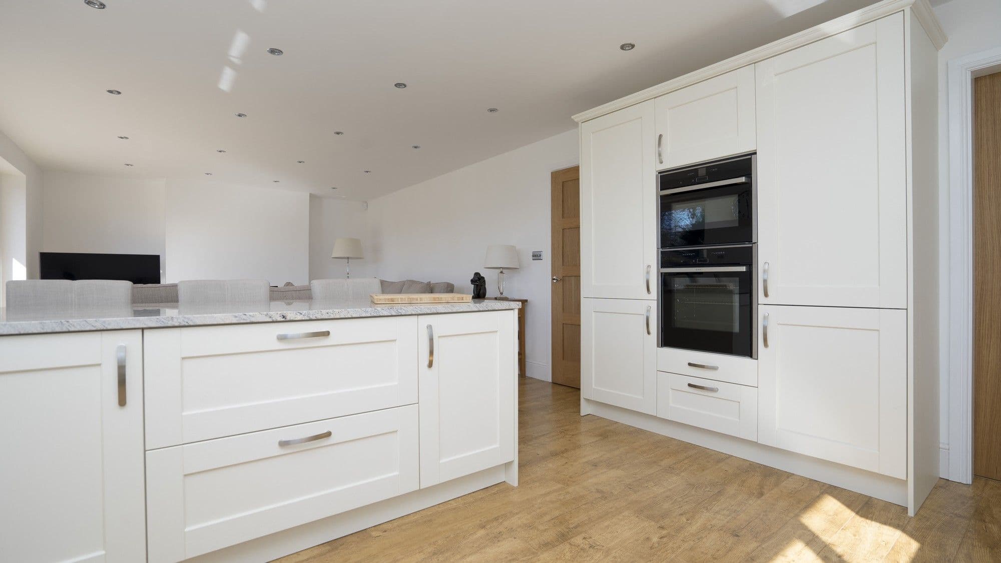 Close up images of the dual slide and hide Neff ovens and floor to ceiling cabinets.