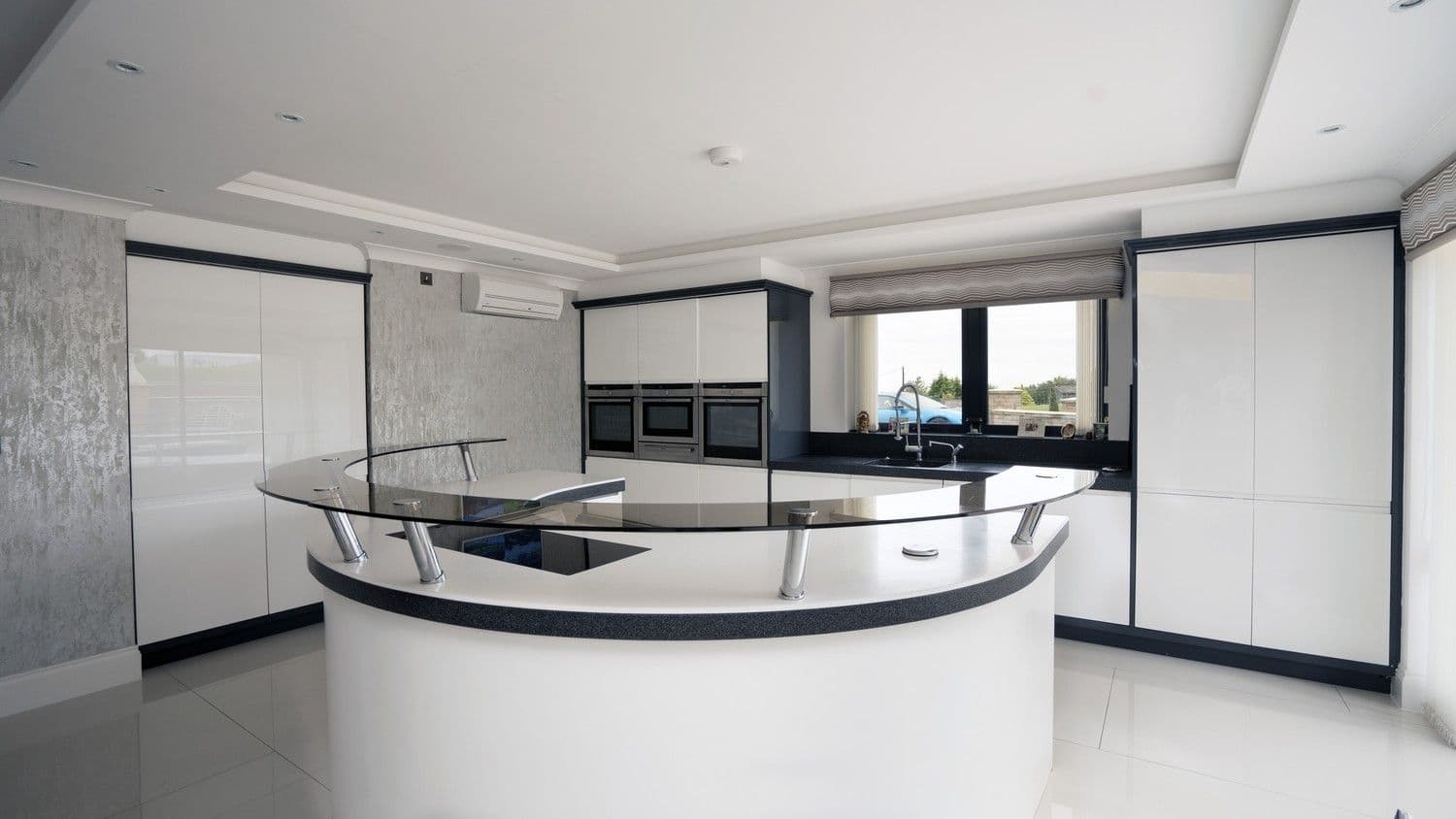 Close up of this stunning one of a kind kitchen island with stand off counter, this kitchen features a Corian worktop and Corian doors.