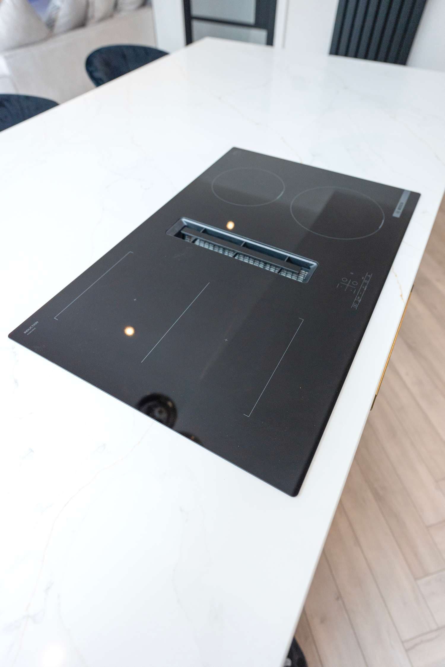 Modern ceramic hob with integrated extractor.