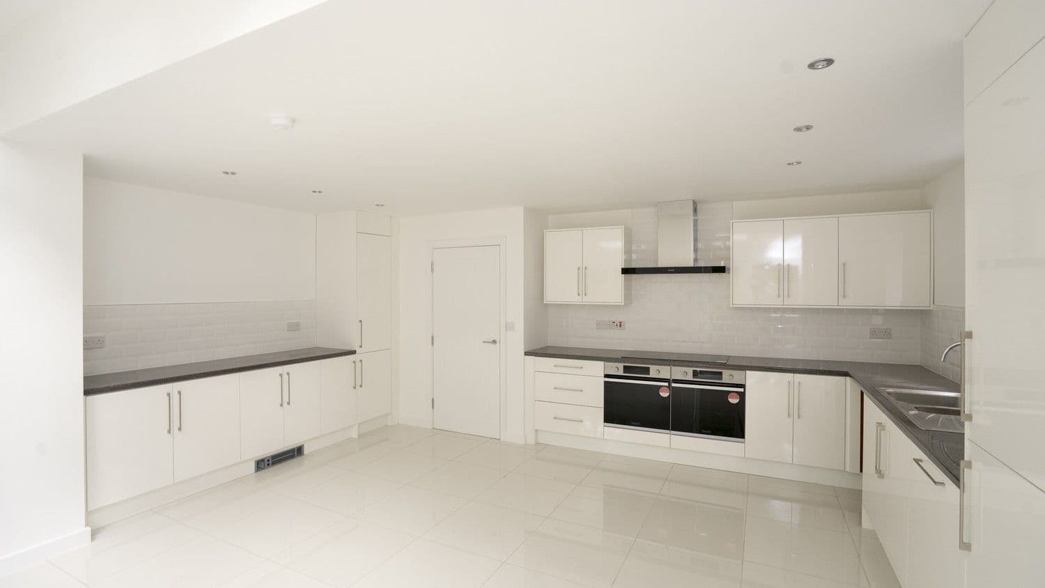 Alternative view of the gloss white kitchen installed in Liverpool, giving the space and bright and open feel.