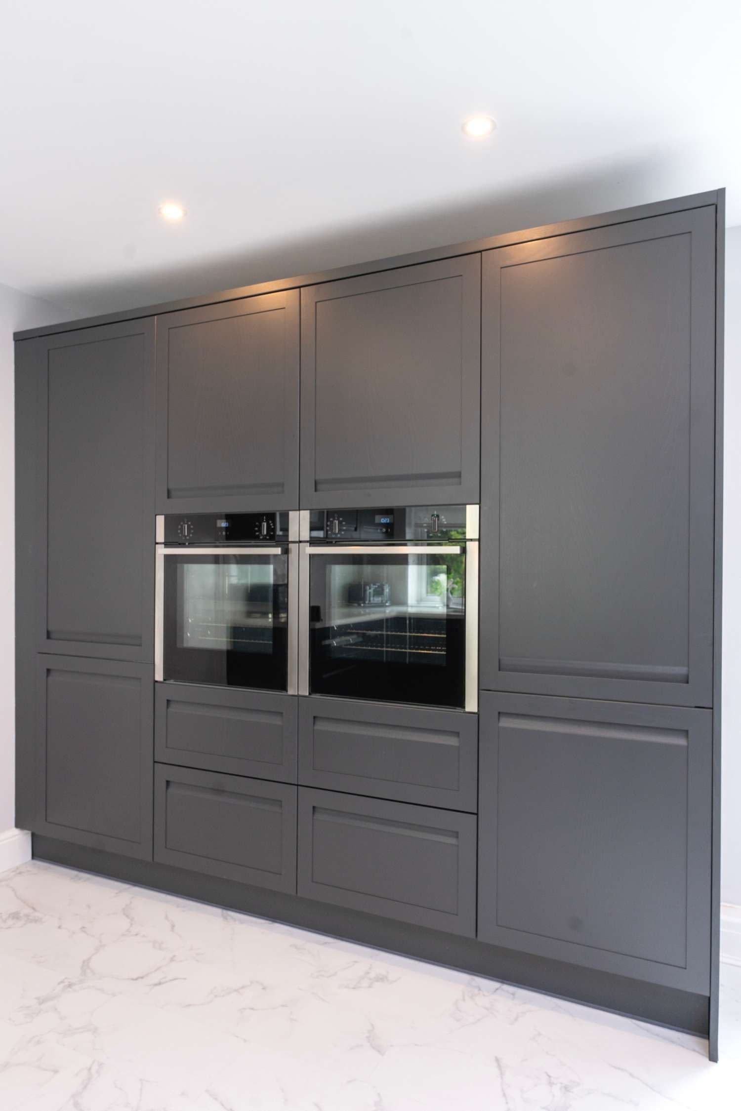 Floor to ceiling cabinets housing dual ovens.