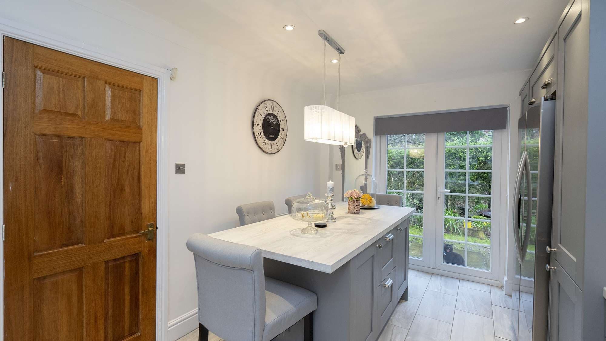 Kitchen island in grey shaker with white worktop.