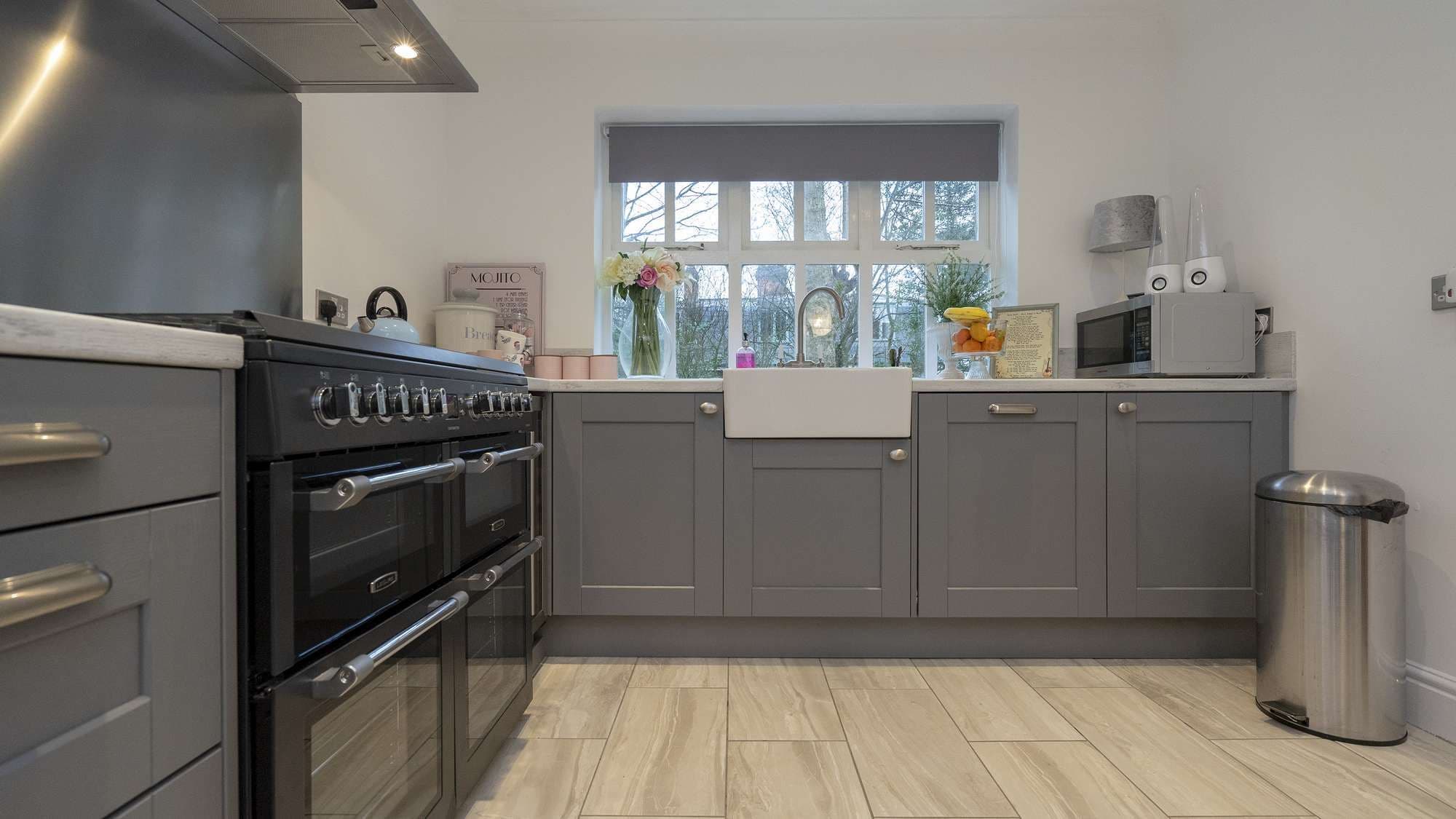 Close up of the lower cupboards with large dual oven and ceramic sink.