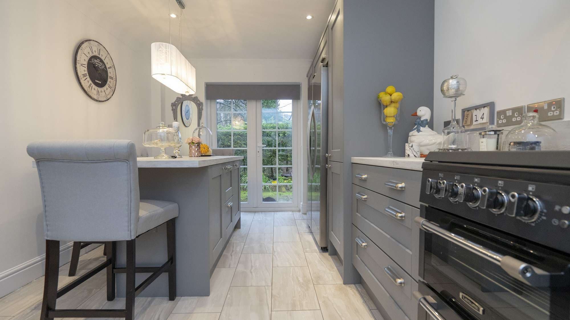Alternative straight on view showing the kitchen island and fridge/freezer housing.
