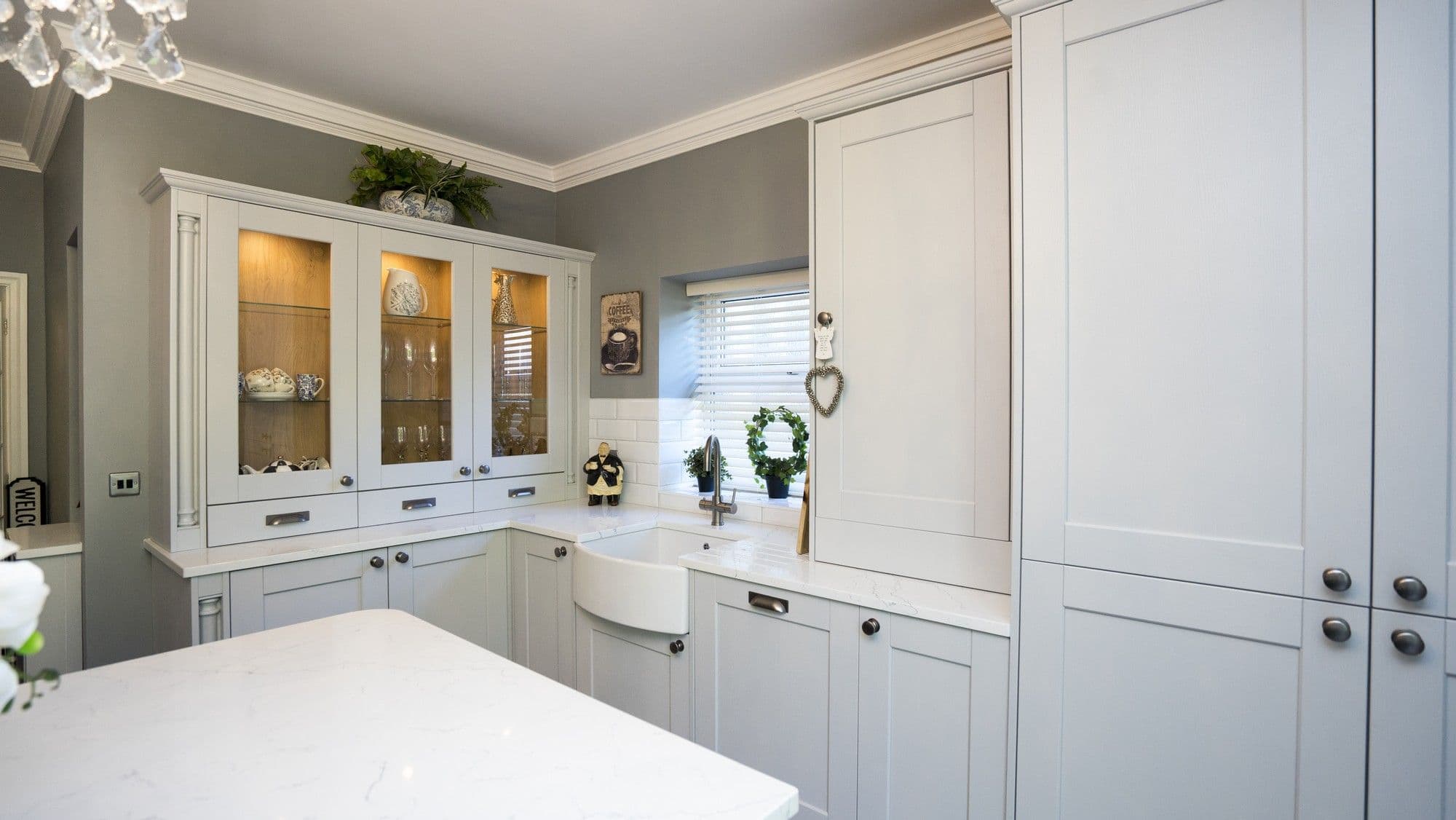 Alternative view of the sink area showing the glass storage cabinets.