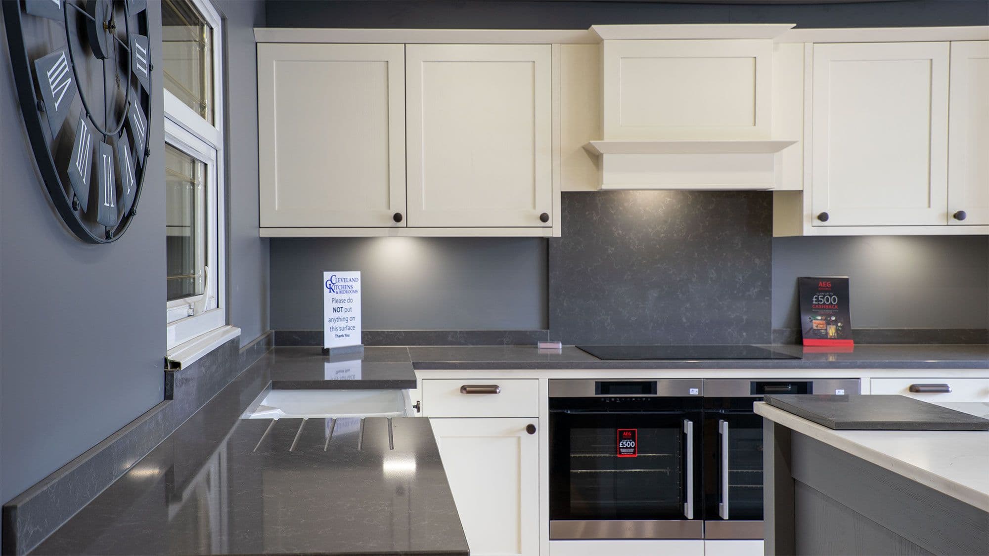 Cream kitchen with dark grey splashback