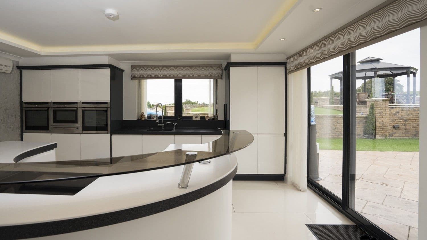Another angle of this kitchen highlighting the indoor/outdoor flow created by the sliding doors.
