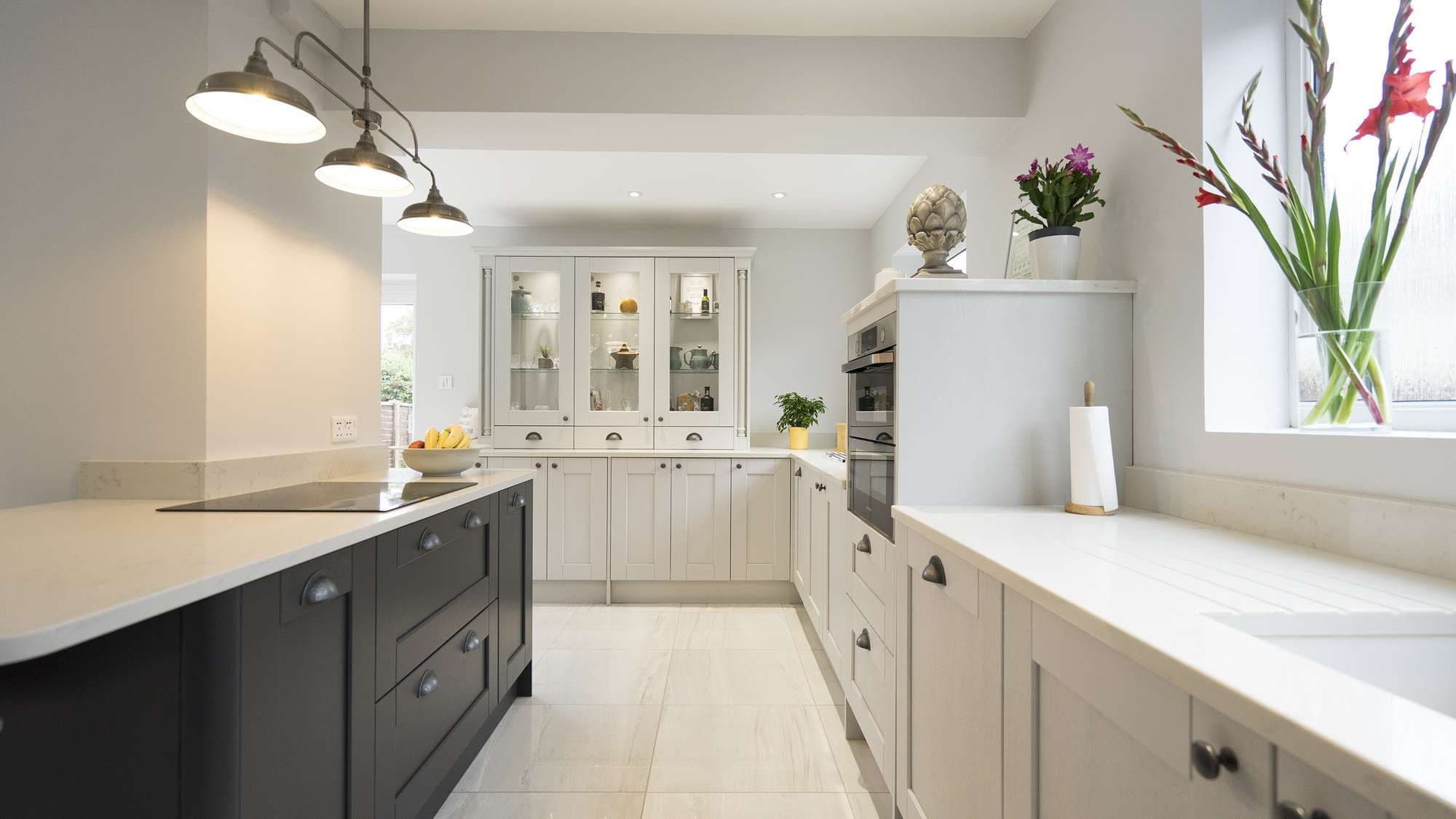 Looking down the kitchen showing the two different colour cupboards and the mid height oven.