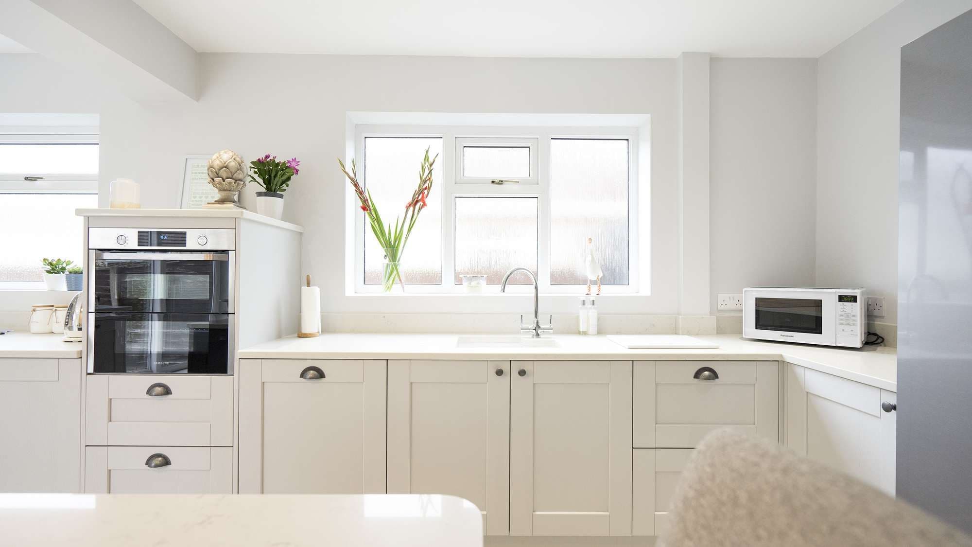 Another view of the family kitchen showing the under-mounted sink area with chrome taps.