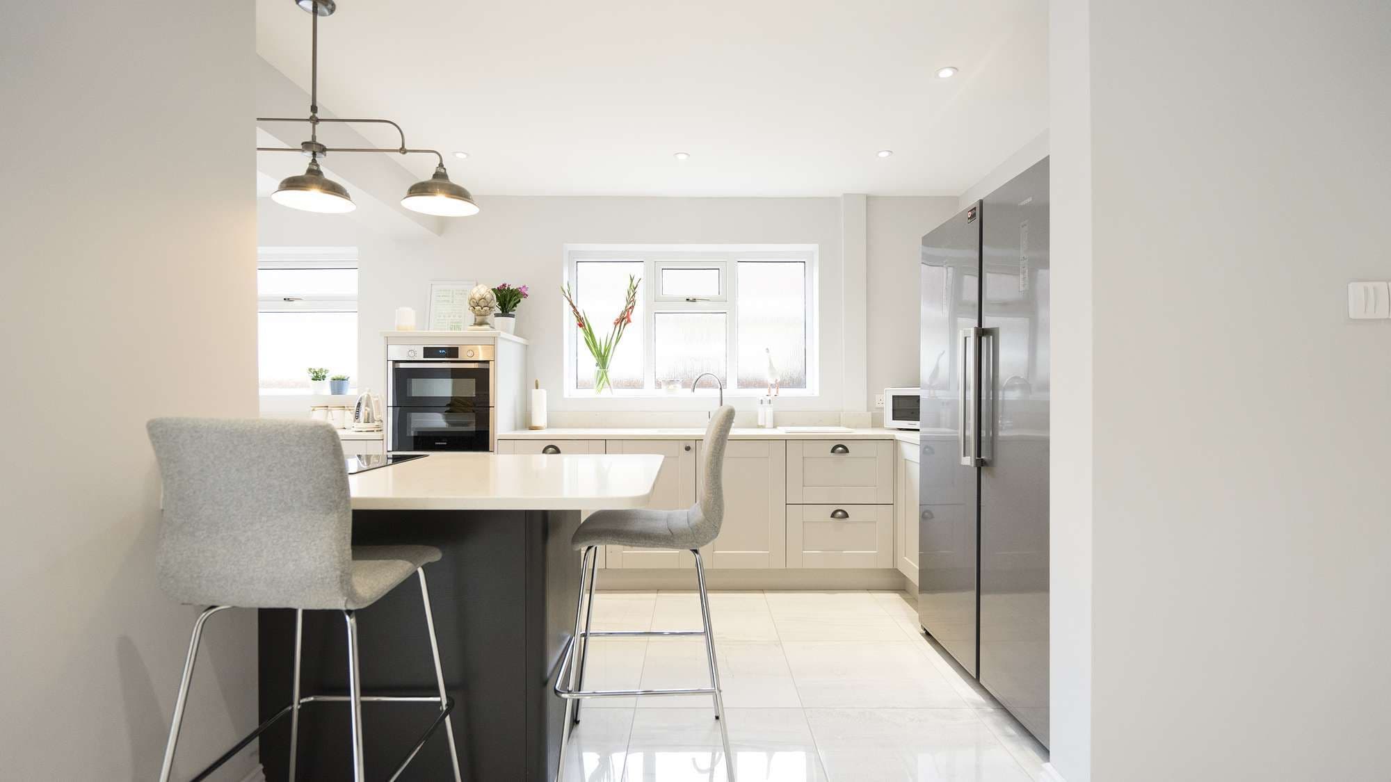 Straight on view of this shaker kitchen in Southport, Large dual american fridge freezer gives plenty of space for keeping food cool.