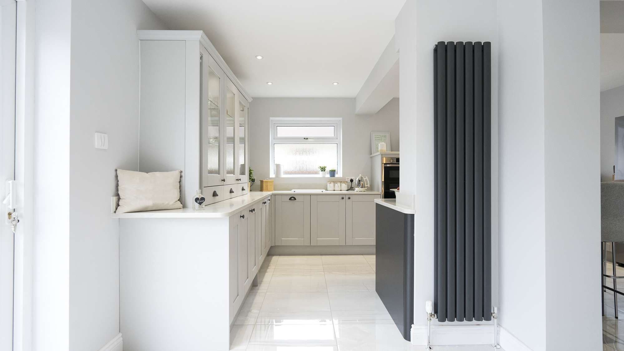 Another view from the other side of the column, Shaker kitchen with glass display cabinet.