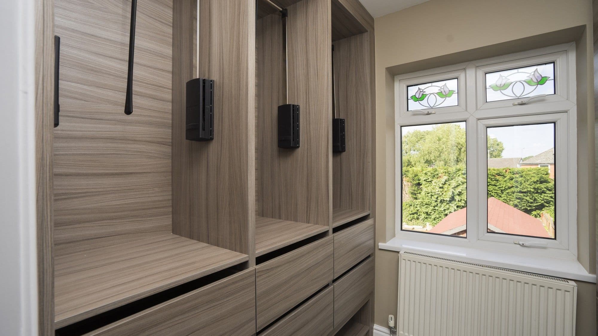 Pull down rail and push open drawers.