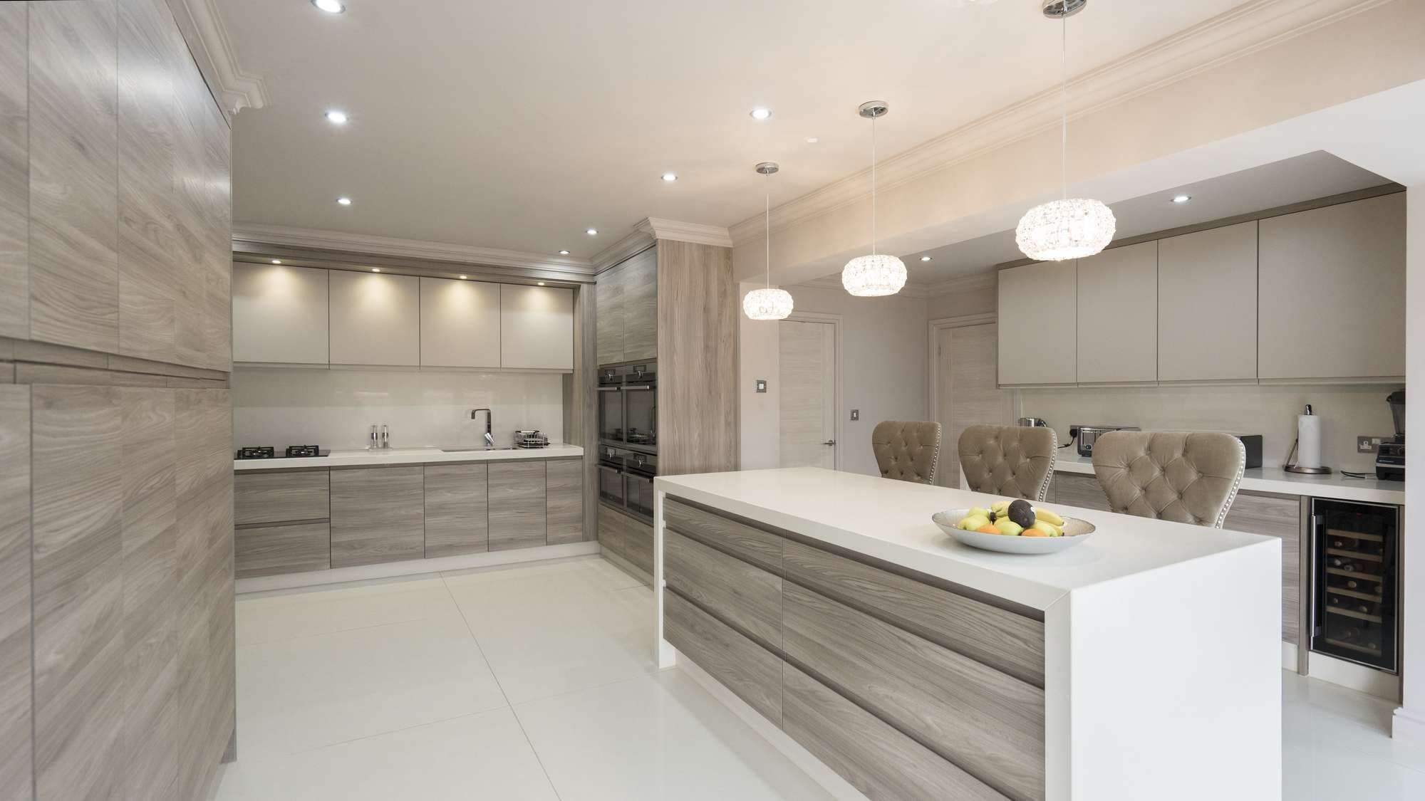 Large kitchen island with up and over granite worktops and button backed stools.