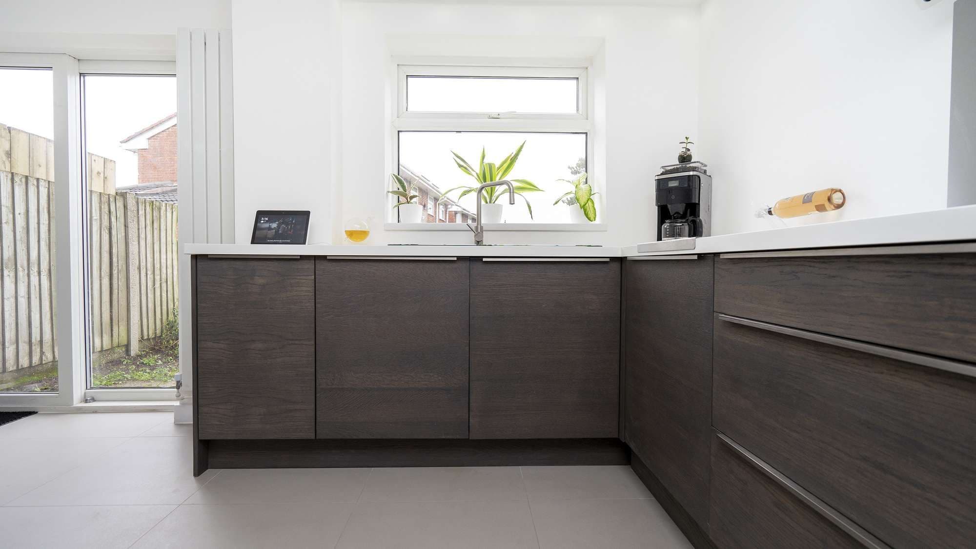 Close up of the bottom units with large slimlin handles and wood effect doors.