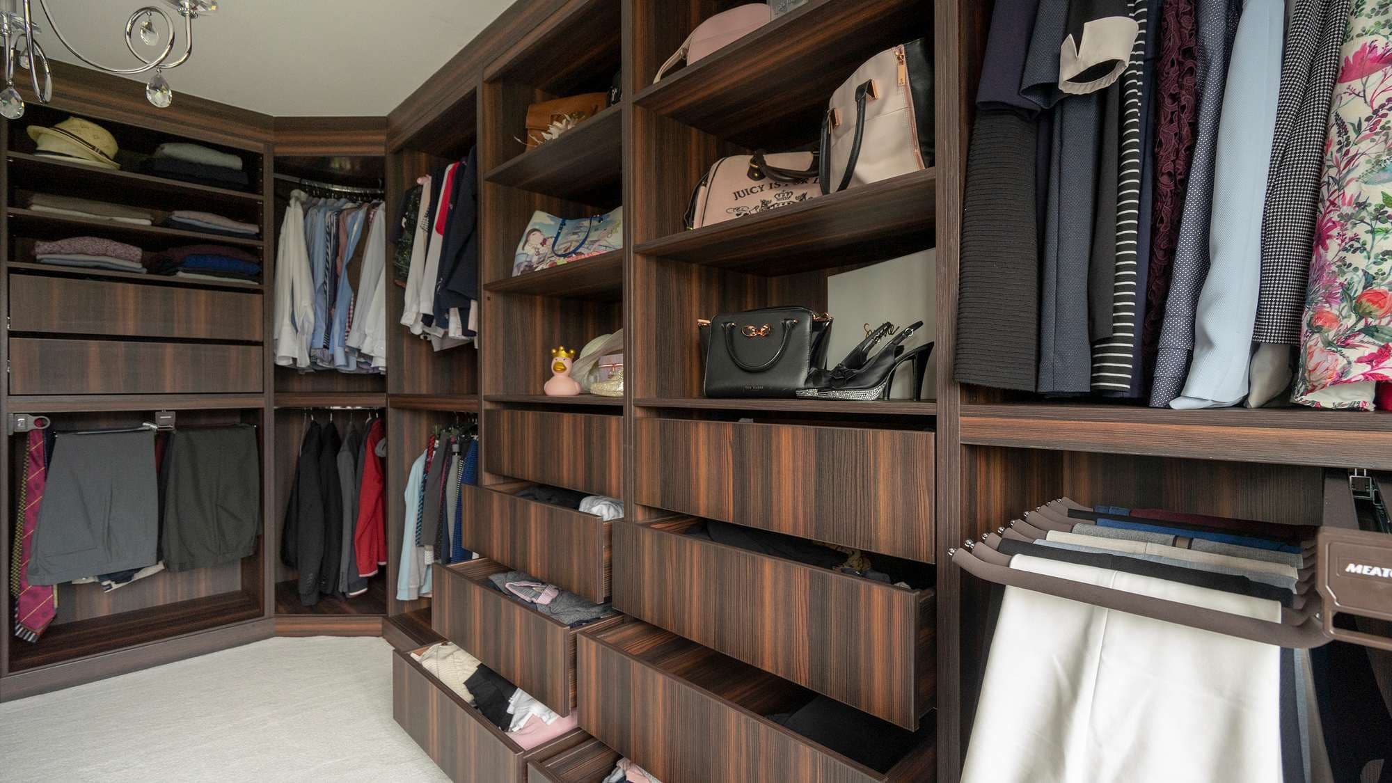 Image detailing the wrap around corner detail of this walk-in wardrobe making the most of the space on offer.