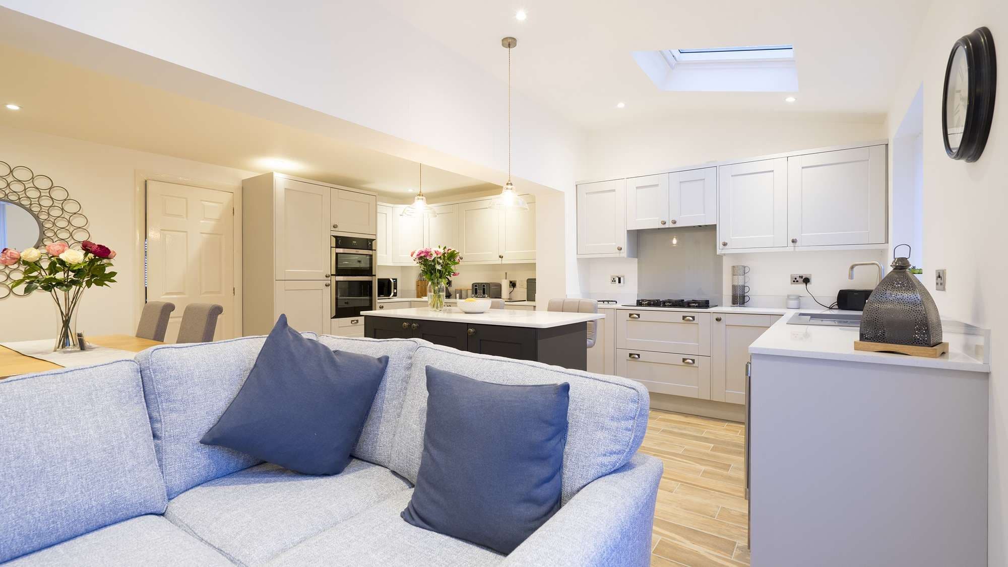 Overview image showing the full kitchen including shaker doors, integrated appliance and Corian worktops all supplied and fitted in Liverpool.