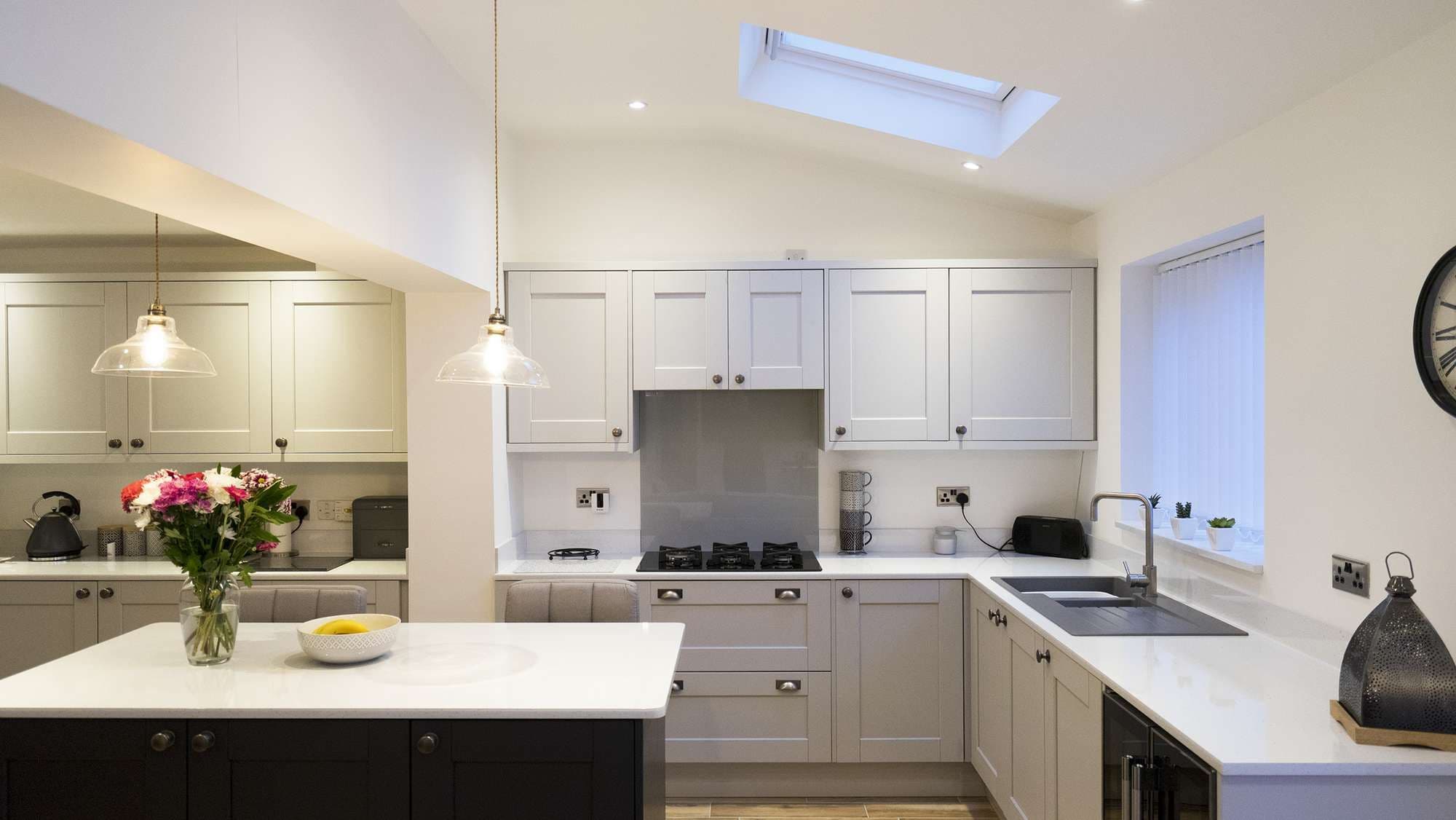 Another angle of the fabulous kitchen showing the industrial style lighting and various appliance.