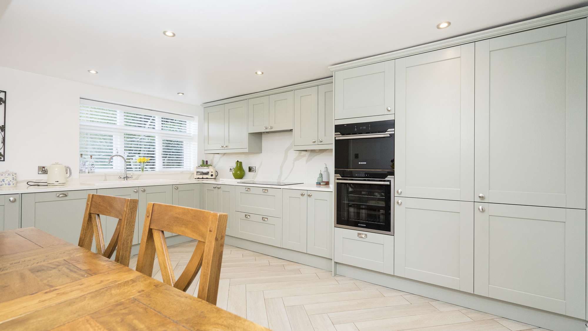 Full view of the full height floor standing cupboard units with integrated fridge/freezer and oven units.