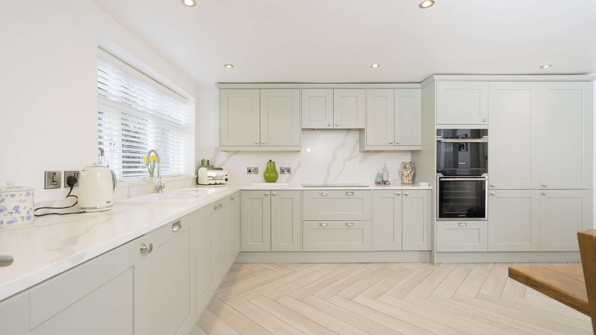 Alternative view of this shaker kitchen, all appliances are integrated and therefore mostly hidden from sight apart from the ovens which can be seen.