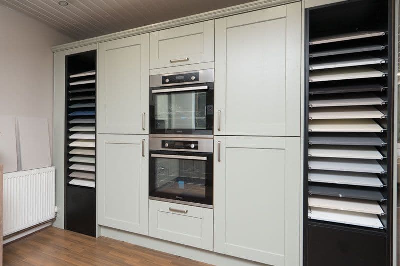 Sage shaker display kitchen with double ovens between door sample racks